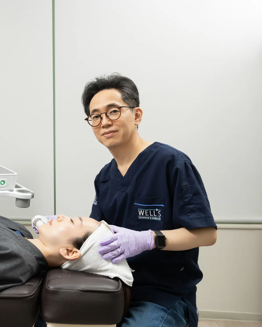 Dr. Won Sin Lee performing a skin treatment at Wells Clinic Seoul